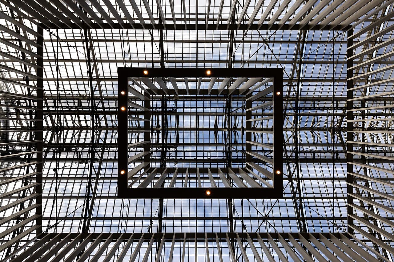 The Rijksmuseum's brick towers reflected in the Museumplein pond