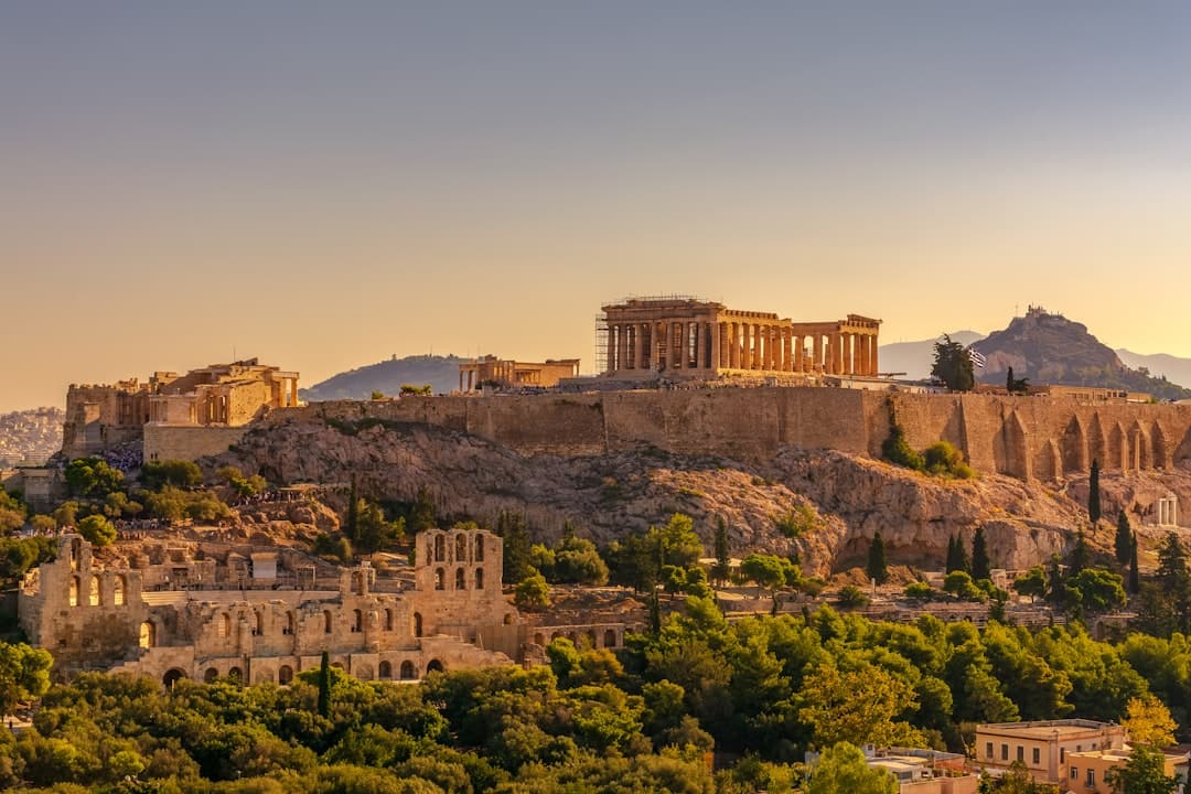 The Parthenon on the Acropolis rock, golden marble against a deep blue sky