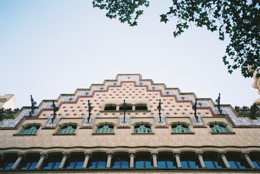 The scaled, bone-like facade of Casa Batlló lit at dusk