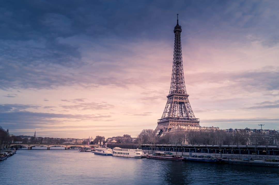 The Eiffel Tower lit at night seen across the river from Trocadéro