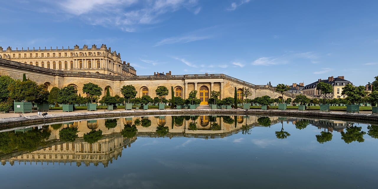 The palace and gardens of Versailles reflected in a basin